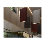 Noren S/72 fabric LED pendant light in dark grey, shown as a tall curved panel among multiple similar pendants in a wood-panelled interior with glass partitions.