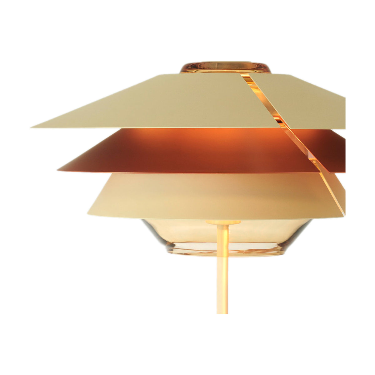 Overlay T50 Cognac Glass Table Lamp close-up showing stacked beige tiered shades above a cognac glass bowl and slim stem, set against a plain white background.