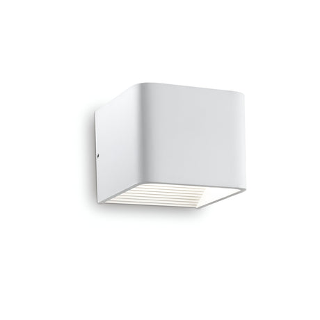 Introducing the Zephyrine LED Wall Light, this sleek and minimalist white fixture is designed with a square shape and smooth edges. It emits a warm 3000K glow from the bottom, creating a softly illuminated ambiance while providing energy-efficient lighting for the eco-conscious home.