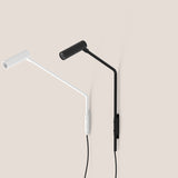 Nivia LED Wall Light in matt black and white, shown with angled arm, cylindrical reading head and narrow wall plate, mounted on a plain neutral background.