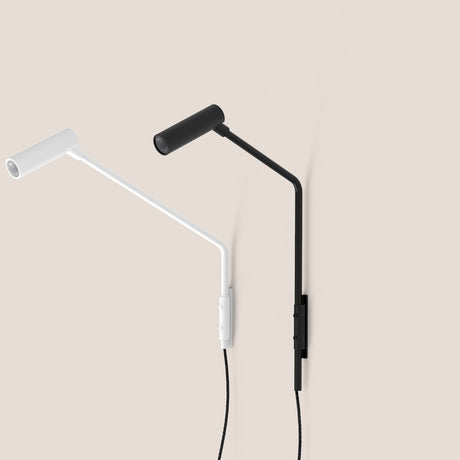 Nivia LED Wall Light in matt black and white, shown with angled arm, cylindrical reading head and narrow wall plate, mounted on a plain neutral background.