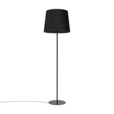 Kilma Ribbed Fabric Floor Lamp in matt black, with a pleated tapered fabric shade on a slim iron stem and round flat base, shown on a plain white background.