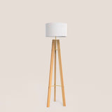 Breeze Fabric Drum Tripod Floor Lamp with light wood tripod legs, slim gold stem and braces, and a white cotton drum shade, shown on a plain background.