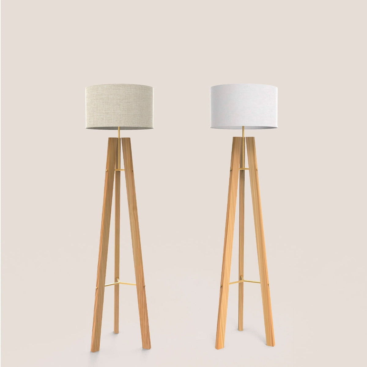 Two Breeze tripod floor lamps with natural wood legs, gold stem and braces, and drum shades in beige and white cotton, on a plain light background.