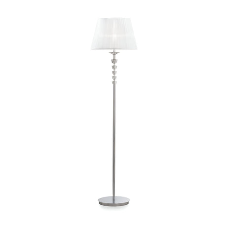 The Solum Floor Lamp - White showcases a sleek silver base and an intricate central pole design, topped with a white organza lampshade. Its chromed metal frame gives the lamp a stylish and contemporary look, making it ideal for various interior settings.