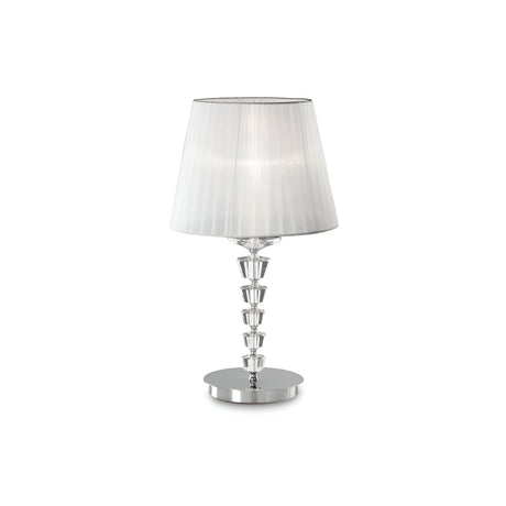 The Solum Large Crystal Table Lamp - White is a modern design showcasing a pleated organza lampshade and a base with stacked, clear crystal-like segments, all gracefully positioned on a chromed metal frame with a round, reflective silver platform.