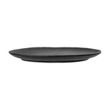 Neri Stoneware Side Plate in black, shown side-on with ribbed sunburst texture radiating from the centre to the rim, on a plain white background.
