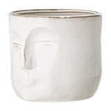 Ignacia Stoneware Plant Pot in white ceramic with a sculpted face in relief, closed eyes and raised nose and lips, rounded form on a plain white background.