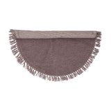 Lenea Round Wool Rug 110cm in purple, shown half-rolled with fringed edge, tufted surface, on a plain white background.