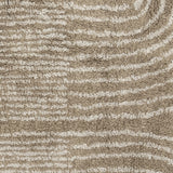 Zeynep Cotton Rug 215x150cm in brown, close-up of tufted cotton pile with curved wave-like lines in a lighter tone against a brown background.
