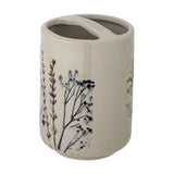 Beige crackle stoneware toothbrush holder with dual compartments and a hand-painted floral stem motif around the lower half, shown on a plain white background.