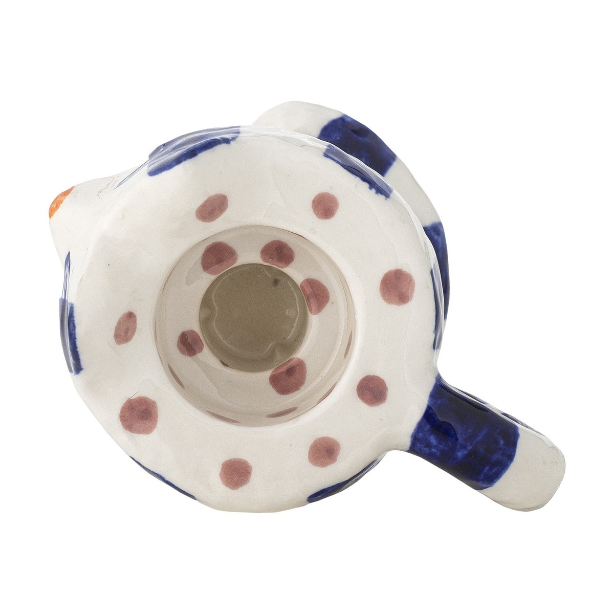 Base view of Caty stoneware cat-shaped candle holder in blue and white, showing the candle opening ringed with painted dots and a curled tail handle.