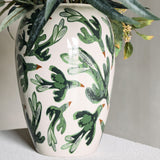 Birdliva Stoneware Vase 33cm in cream with green bird motifs and orange beaks, rounded shoulders tapering to the foot, shown with foliage against a neutral background.