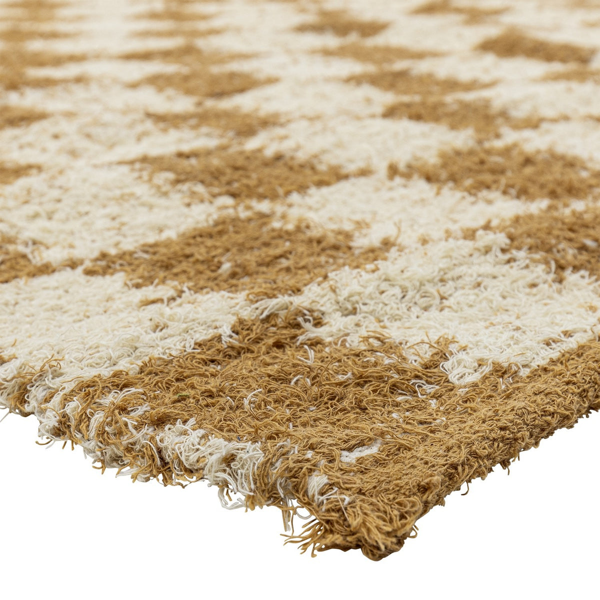 Close-up of the Chola Cotton Rug 200x140cm in brown, showing the woven checkerboard pattern with textured, softened edges between brown and cream squares.