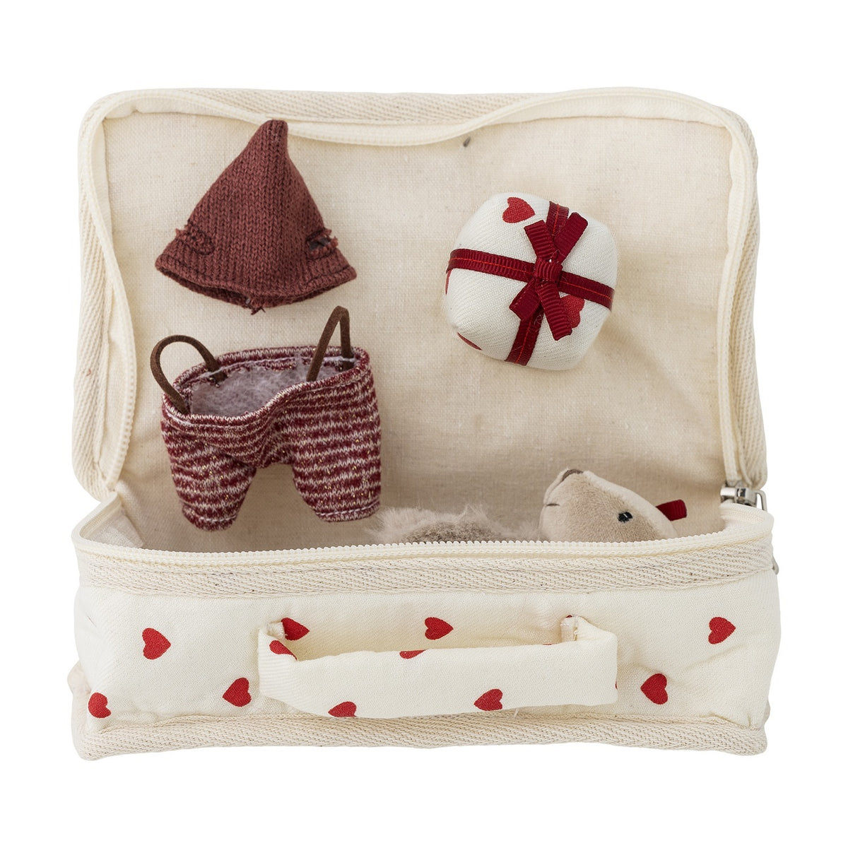Lara Cotton Rag Doll heart-print fabric suitcase open to reveal a knitted brown hat, striped shorts, a small round accessory, and the doll's fluffy ear peeking out.