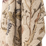 Yoti Floral Cotton Throw in multi, draped close-up showing trailing floral and leaf print on a textured woven beige cotton fabric.