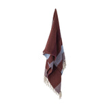 Isnel Red Striped Throw hanging against a plain white background, showing a ribbed woven texture in red and blue stripes with knotted yarn fringe at the ends.