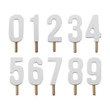 Set of white wooden number candles 0-9 with wooden stick holders, plain cut-out digit shapes on a white background.