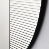 Close-up of the vertical ribbing running out to the rim, each groove catching the light along the edge of the glass.