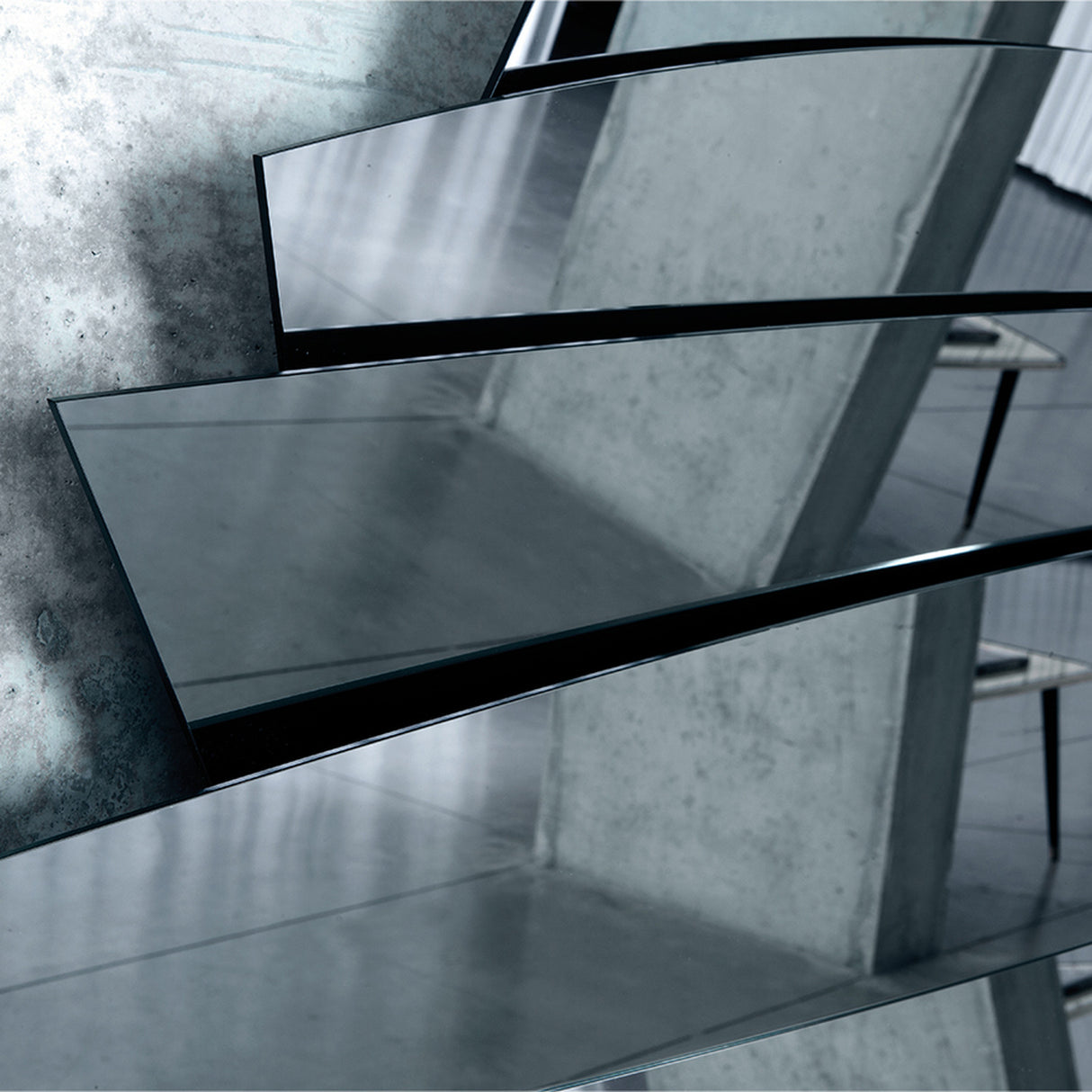 Close-up of the polished blade edges where the blades meet, catching the light against a darker reflection behind.