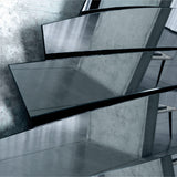 Close-up of the polished blade edges where the blades meet, catching the light against a darker reflection behind.