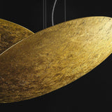 Close-up of the Gong Aluminium Disc LED Pendant Light 60cm, showing its shallow gold leaf finish disc with a textured metallic surface, suspended on fine wires against a black background.