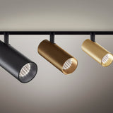 Three Street 5 aluminium LED track spotlights in black, bronze, and brass finishes, each with a cylindrical head and honeycomb louvre, mounted on a black track against a neutral background.