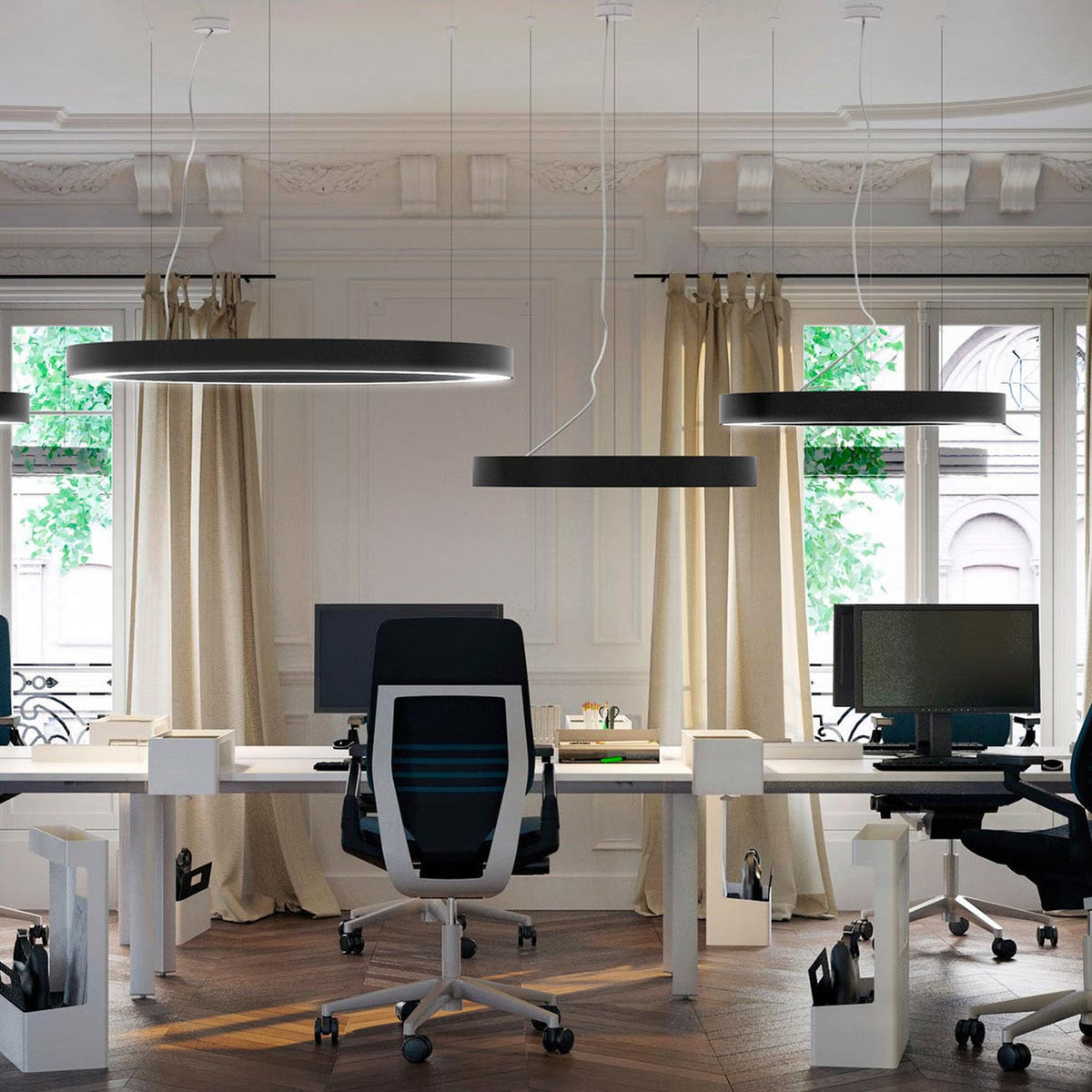 Large matte black ring-shaped LED pendant lights, 123cm diameter, hung over office desks with monitors and black task chairs in a period-style room.