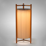 Kando P/111/R rechargeable floor lamp with pleated white ribbon cylinder shade, dark top disc, and slim wooden frame on a three-armed foot, shown on a plain white background.