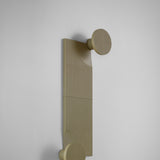 Arid Wall Light Tile in Textured Olive Grey, a fluted aluminium panel mounted beside a round wall light with ribbed shade, shown against a plain light grey background.