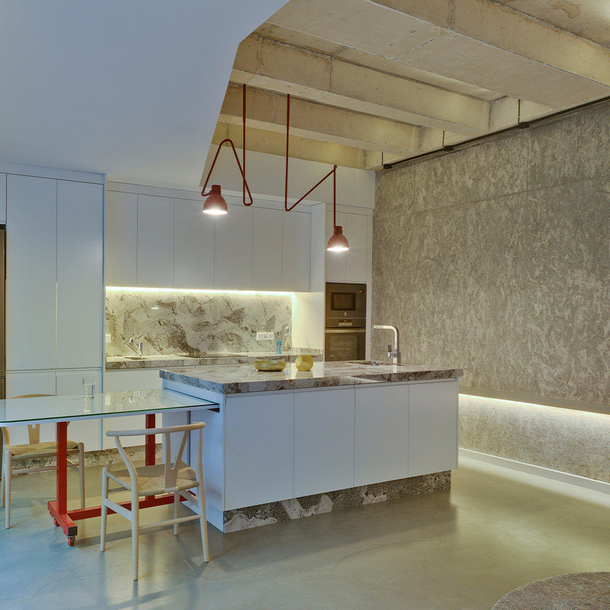 Blux C Aluminium Dome Ceiling Light in red, shown as two pendants with angled zig-zag stems and dome shades above a white kitchen island with marble worktop.