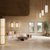 Roma Glass LED Pendant Light in Brushed Bronze with slim vertical bars around glowing white panels, shown in art deco style above a living room seating area alongside matching wall lights.