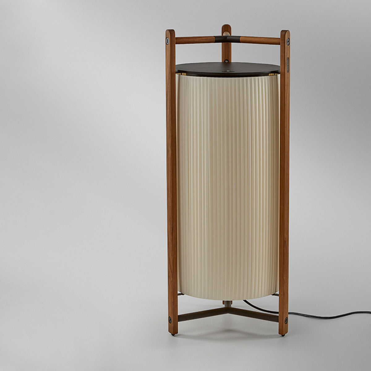 Kando P/111 Ribbon LED floor lamp with a tall pleated white cylinder shade inside a wooden three-legged frame and dark top disc, shown on a plain grey background.