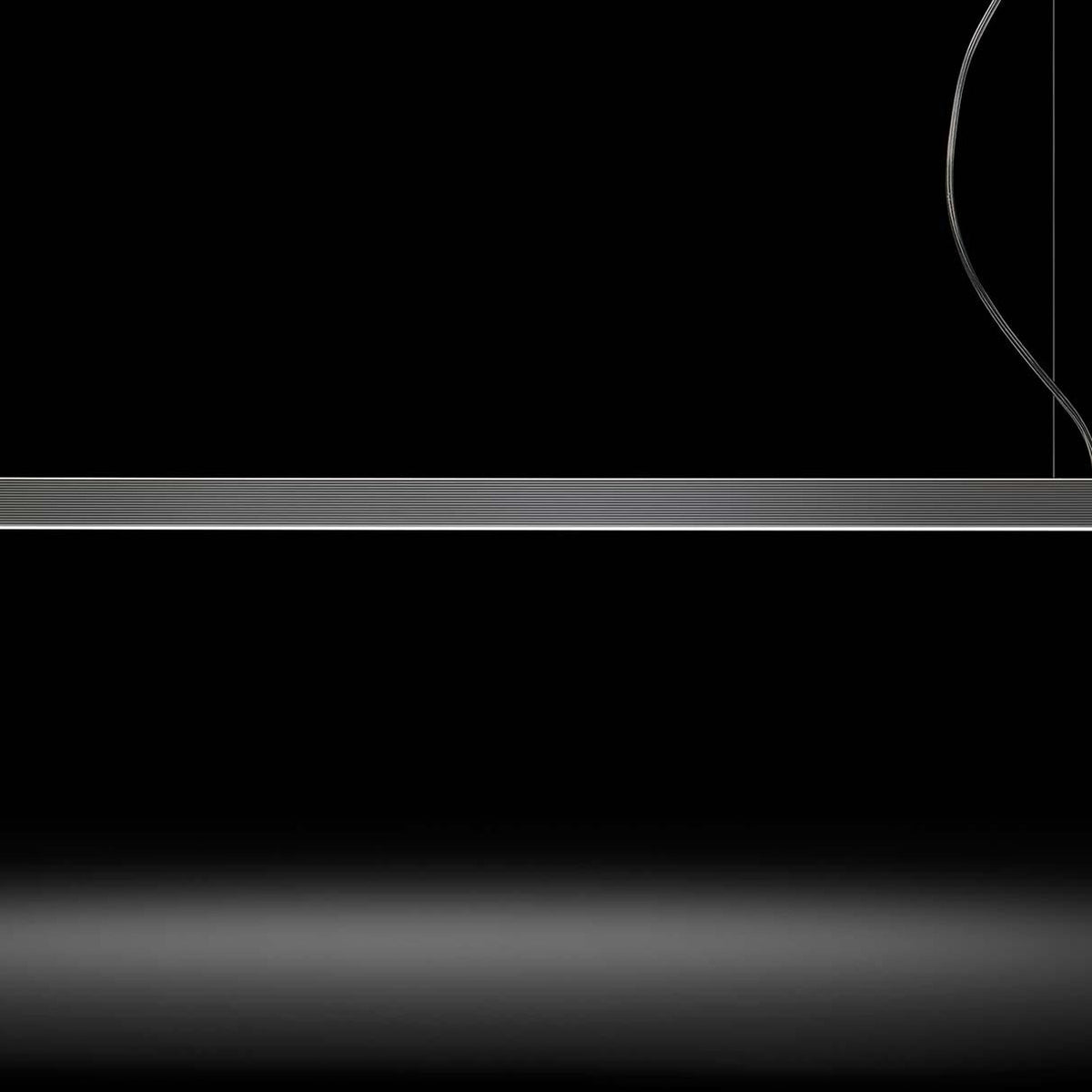 Brooklyn Line Aluminium Linear LED Pendant Light, 152cm slim horizontal bar in black and white finish, suspended by thin cables against a dark background.