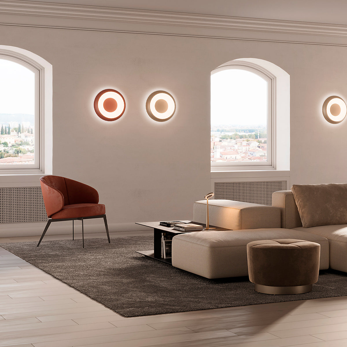 Superbold LED Wall & Ceiling Light 44.3cm, round flush fittings with warm white glowing rings, shown on a living room wall above a sofa and armchair.