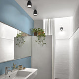 Nut PF/10 black outdoor ceiling lights with rounded bell-shaped shades mounted on a bathroom wall and ceiling near white tiles and a blue accent wall.