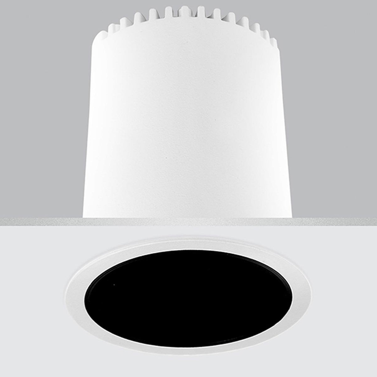 Nick Aluminium Round Recessed LED Downlight 6cm in white, showing the cylindrical housing above the ceiling and the round white trim with black interior below, set on a plain grey background.