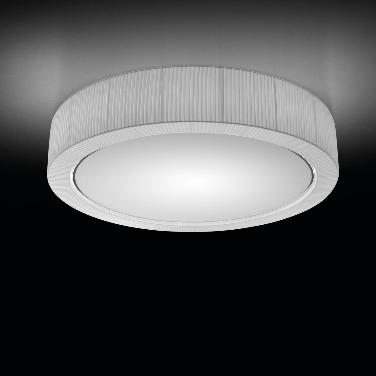 Urban PF/120 Ribbon LED ceiling light, a large round fixture with a white ribbed drum shade and glowing white diffuser, shown against a dark background.