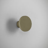 Arid A/01 round aluminium LED wall light with vertically fluted disc in Textured Olive Grey finish, mounted on a short stem against a plain light background.