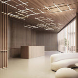 Hilow White Diffuser Frame LED pendant lights arranged in multiple crossed linear grids on a wood-panelled ceiling above a reception desk and curved cream sofa.