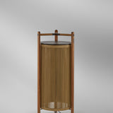 Kando P/111 Wood Outdoor Floor Lamp in Sand, showing a teak frame with vertical sand nautical cord cylinder and dark brown top disc, set against a plain light grey background.