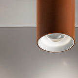 432 Ways Cylinder LED Ceiling Light in brown, close-up of the cylindrical surface-mounted fixture with recessed white trim and integrated LED, against a plain grey ceiling.