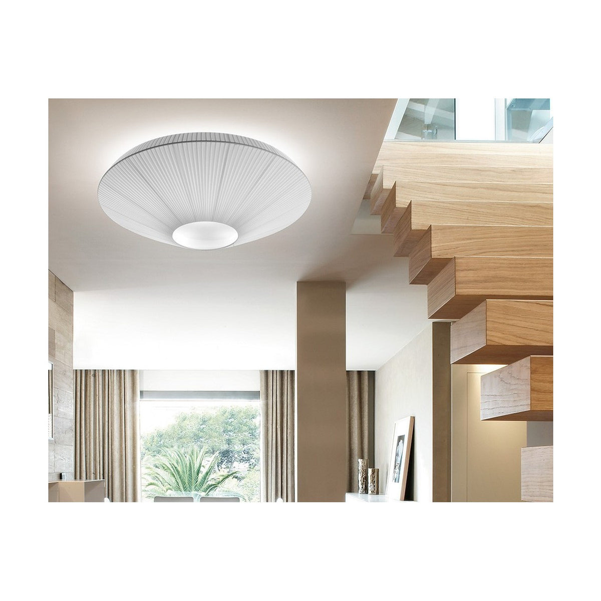 Siam 80 Ribbon Cone ceiling light in white, shown mounted above a staircase with wooden steps, its pleated cone shade and round central diffuser softly illuminating the hallway.