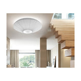 Siam 80 Ribbon Cone ceiling light in white, shown mounted above a staircase with wooden steps, its pleated cone shade and round central diffuser softly illuminating the hallway.