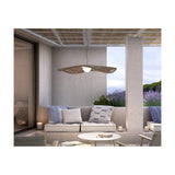 Mediterrània S/105 outdoor pendant light with wide disc-shaped brown fibre slat shade and white ribbed LED diffuser, hung above a patio seating area.