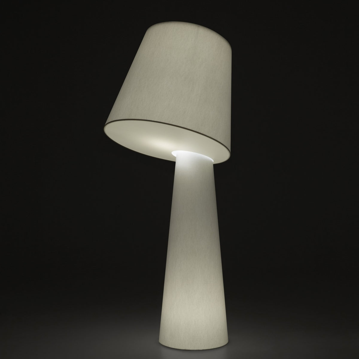 Big Brother 3 Light Fabric Floor Lamp in white, featuring a tall tapering base and a tilted drum shade that glows when lit, shown against a dark background.
