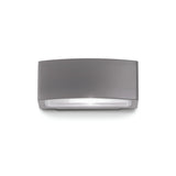 The Lunar Outdoor Wall Light - Anthracite features a sleek, rectangular LED design with an anthracite finish and a transparent cover, specifically crafted for outdoor use. Rated IP55, this fixture is mounted against a plain white background, showcasing its minimalist and modern aesthetic.