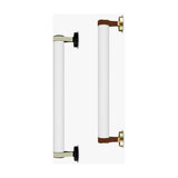 Roseline LED Ribbed Glass Linear Wall Light shown in two sizes, with fluted clear glass cylinders held by beige and brown straps on round black and brass bases, set against a plain white background.