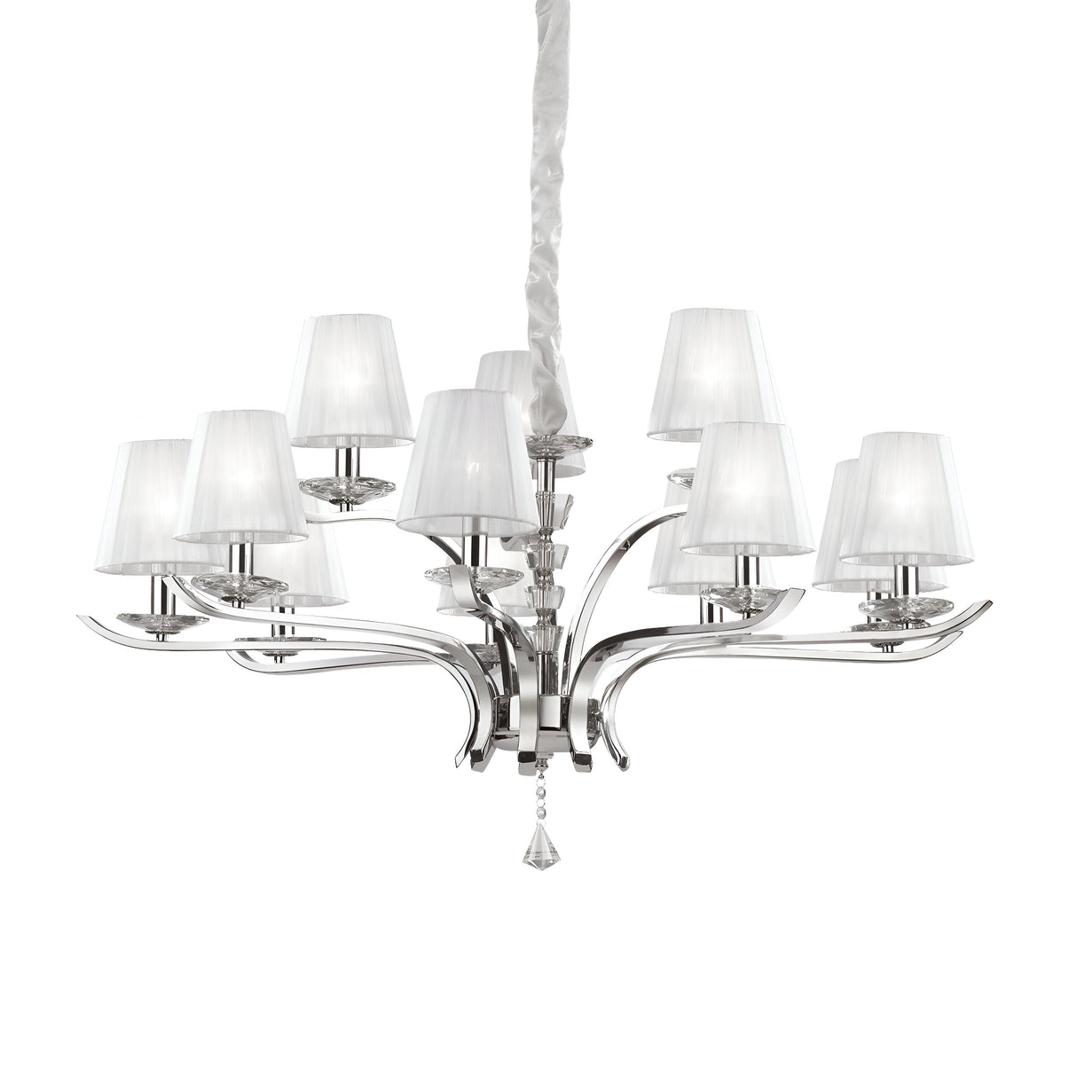 Introducing the Solum 12 Light Chandelier - White, a contemporary masterpiece that boasts a sleek silver design with multiple gracefully curved arms. Each arm is adorned with a petite white lampshade, and the central stem is elegantly wrapped in white fabric. Accentuated by dangling crystal elements, this chandelier creates an eye-catching statement, perfect for any space.