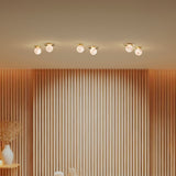 Royal Alabaster Flush Ceiling Lights with Disc in polished brass, shown in pairs along a wall-panelled room with warm, glowing globe shades.